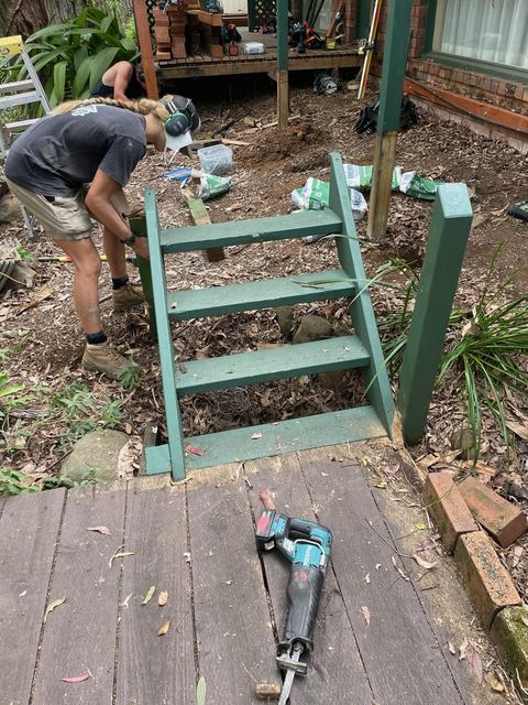 Carpenter checking an old set of painted timber stairs before they come out