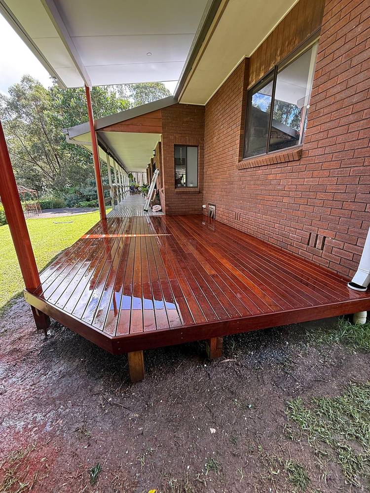 Hardwood deck wrapping around a brick home