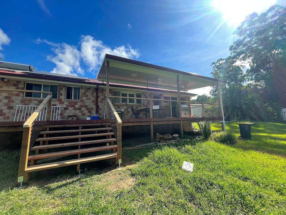 Rough sawn hardwood frame, merbau decking, Versiclad roof and saw tooth stringer staircase in Moonee Beach