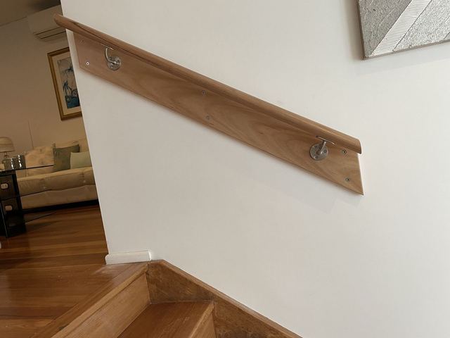 New timber handrail fixed to a stair wall