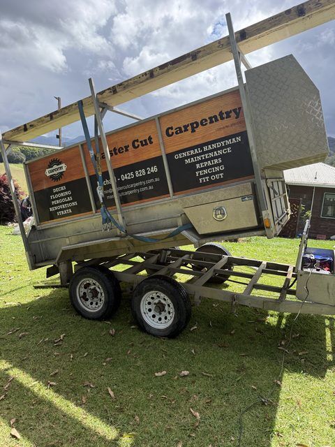 Master Cut Carpentry tipper trailer tipped up on a lawn